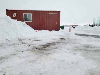 Shipping container hockey ice warming house in snow